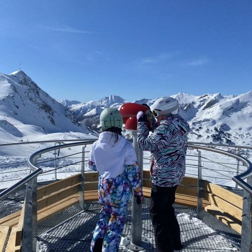 Zwei Skikinder auf der Aussichtsplattform mit Fernglas sicht über Obertauern